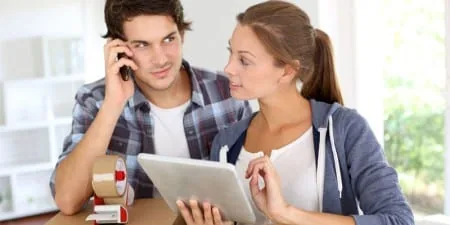 Couple planning their international move on a tablet